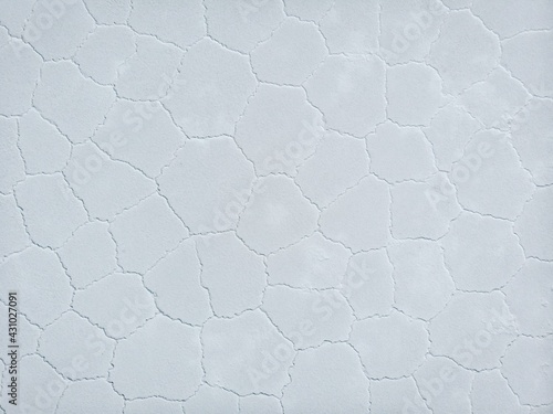 Aerial top down view of hexagonal shaped salt flat pattern structure of Salar de Uyuni lake Potosi Bolivia South America