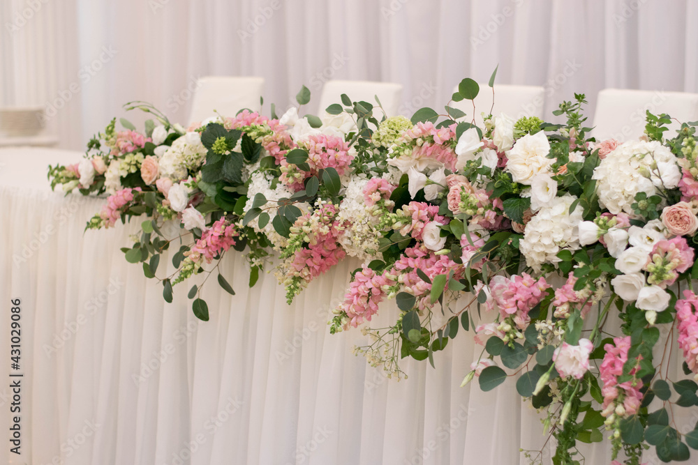 Main table at a wedding reception with beautiful fresh flowers