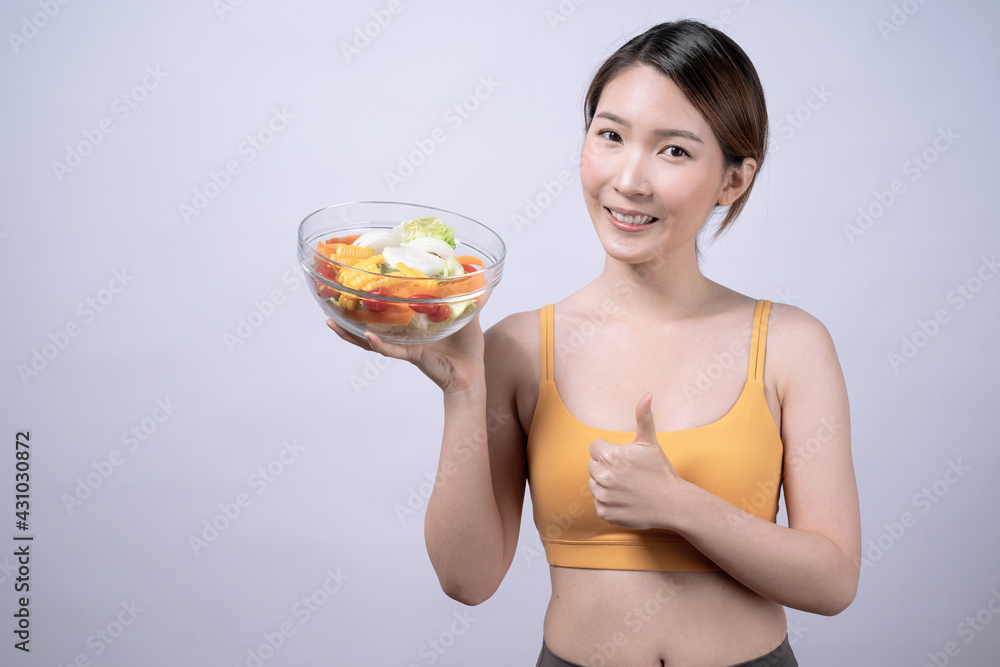 Asian woman eat vegetable salad to stay healthy, Organic food for health, Isolated on a white background. Asian woman eat vegetable salad to stay healthy, Organic food for health, Isolated on a white background.