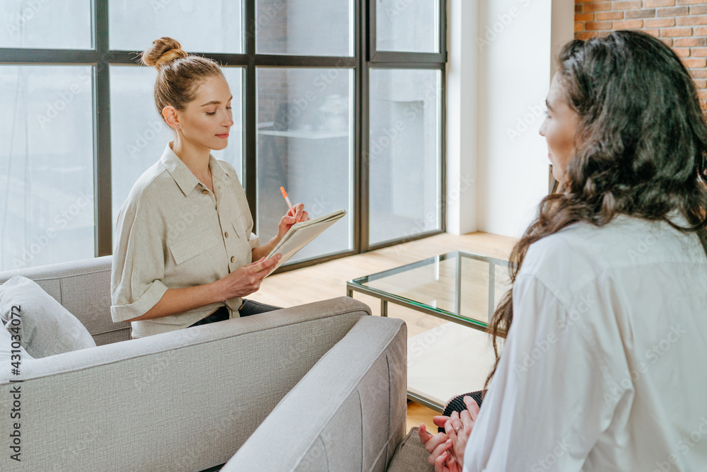 Female coach interviewing her trainee indoor Female coach interviewing her trainee indoor