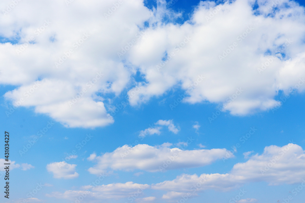 Blue sky with cumulus clouds. White clouds like cotton wool. Beautiful sky on a hot sunny day Blue sky with cumulus clouds. White clouds like cotton wool. Beautiful sky on a hot sunny day