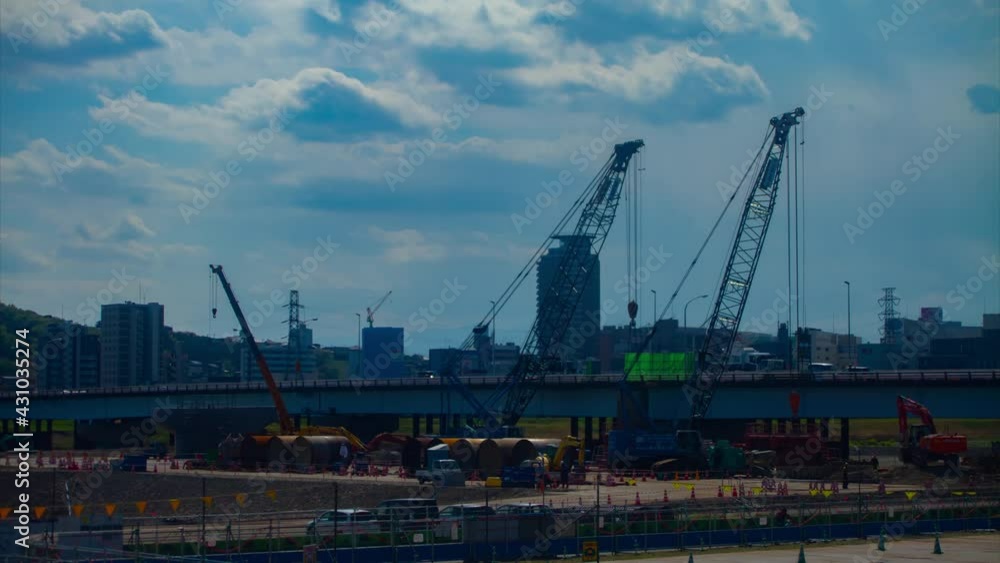 A timelapse of moving cranes at the under construction daytime tilt A timelapse of moving cranes at the under construction daytime tilt