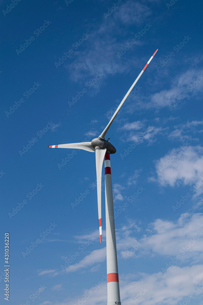 Wind turbine that stand out against the blue summer sky of the Tuscan countryside Wind turbine that stand out against the blue summer sky of the Tuscan countryside