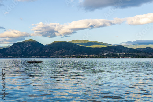 Beautiful calm summer morning on the lake with clouds on the sky