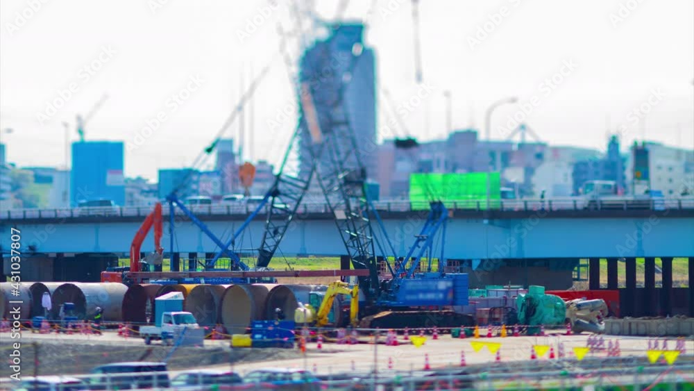 A timelapse of moving miniature cranes at the under construction tiltshift tilting