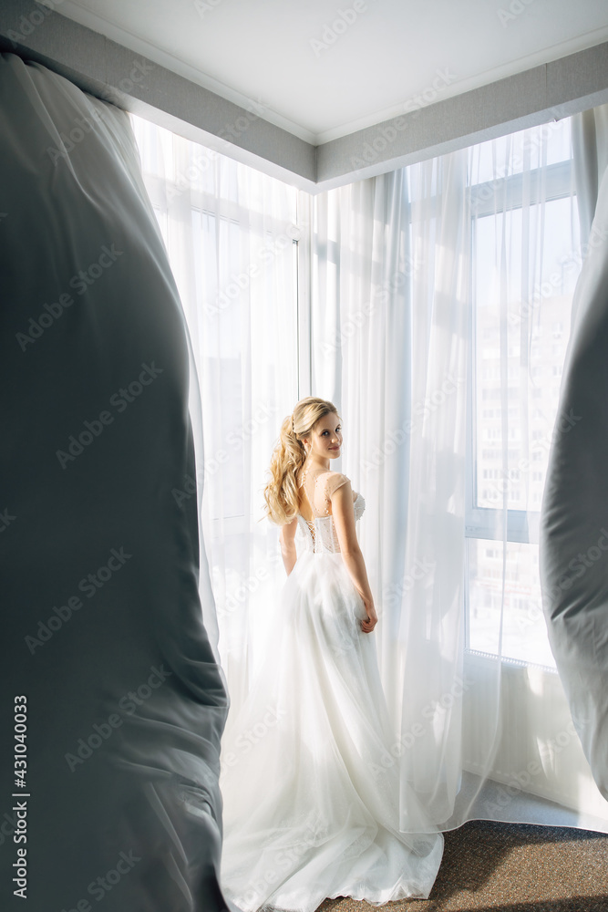 bridesmaids swirl the curtains, the bride turns and smiles. luxury frame of hotel fees. bridesmaids swirl the curtains, the bride turns and smiles. luxury frame of hotel fees.