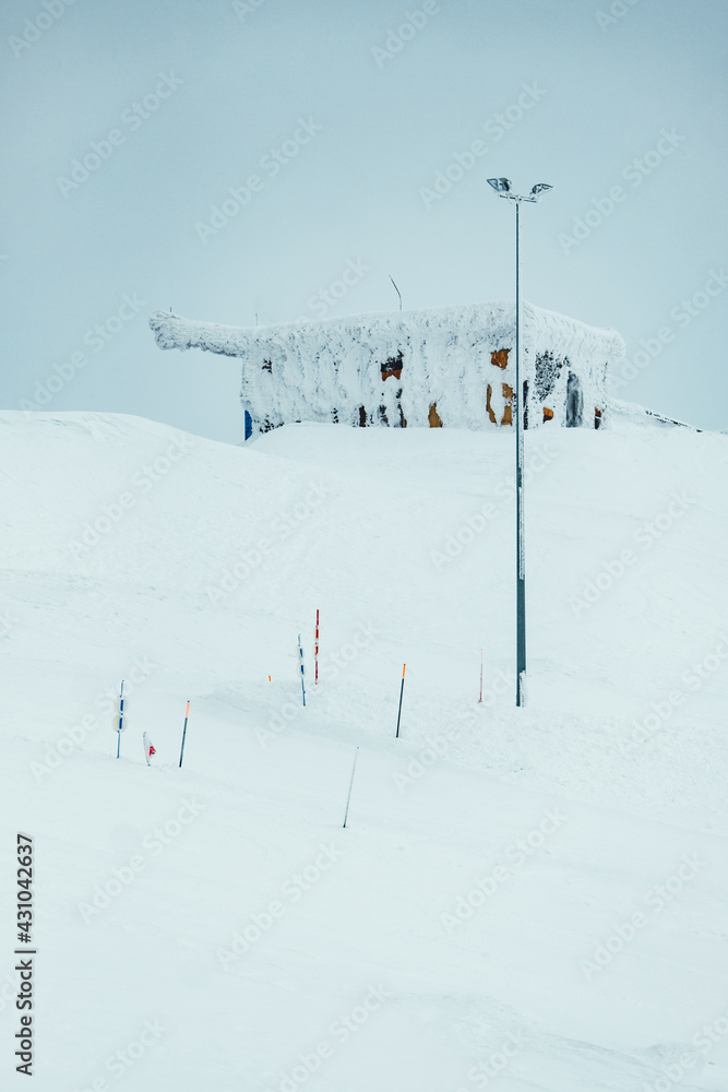 snowy house on top of a snowy mountain 