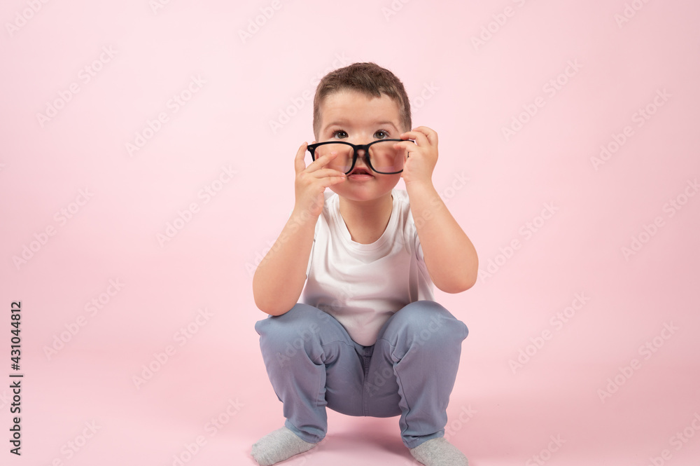 Cute preschooler and transparent glasses,close up portrait on pink background Cute preschooler and transparent glasses,close up portrait on pink background