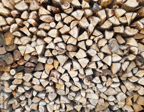 Background of chopped wood lying on top of each other. Pile of chipped wood close-up