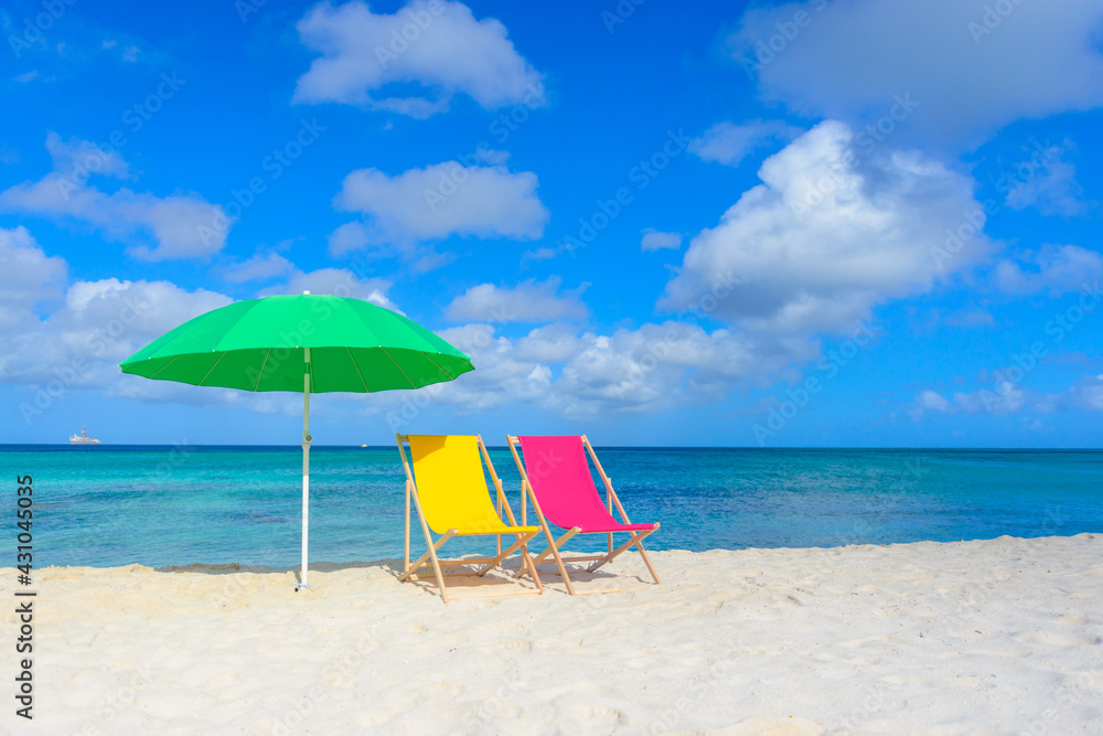 Colorful beach lounge chairs and umbrella at the beach