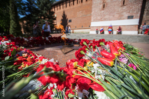flowers at the memorial fire. the memory of the fallen soldiers in the military conflict. the ceremony of farewell to the fallen heroes. flowers at the monument as a symbol of grief
