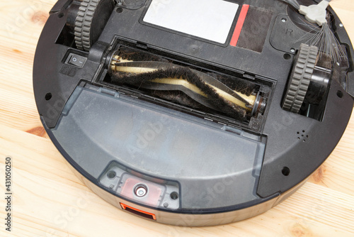 Replacement of the brush of a robot vacuum cleaner with hair, close-up. photo