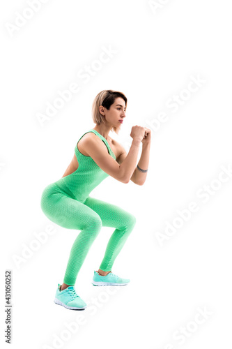Studio shot of an athletic woman doing squats isolated over whit