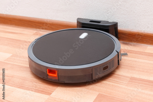 Robot vacuum cleaner go to charging dock after it is finished. Robotic Vacuum