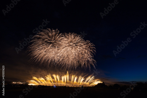 a crowd of people came to the festival, a festival of fireworks, explosions of pyrotechnic charges, volleys of salutes against the backdrop of happy people rejoicing in the beautiful spectacle, multic