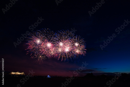 a crowd of people came to the festival  a festival of fireworks  explosions of pyrotechnic charges  volleys of salutes against the backdrop of happy people rejoicing in the beautiful spectacle  multic