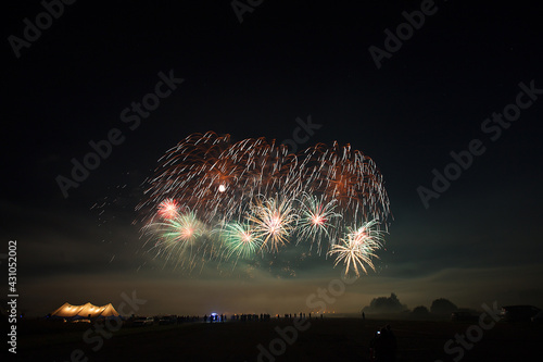 a crowd of people came to the festival, a festival of fireworks, explosions of pyrotechnic charges, volleys of salutes against the backdrop of happy people rejoicing in the beautiful spectacle, multic photo