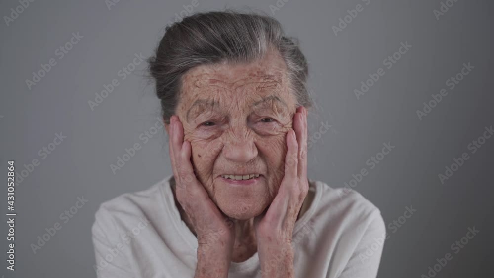Smiling aged senior lady with denture in studio on gray background. Positivity and longevity. Pensioner feeling satisfied. You are never to old to be happy. Cheerful elderly woman laughing Smiling aged senior lady with denture in studio on gray background. Positivity and longevity. Pensioner feeling satisfied. You are never to old to be happy. Cheerful elderly woman laughing