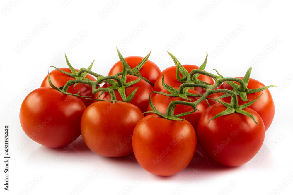 Fresh cherry tomatoes with a sprig isolated on a white background. Tomato branch. Fresh tomatoes with green leaves. Fresh cherry tomatoes with a sprig isolated on a white background. Tomato branch. Fresh tomatoes with green leaves.