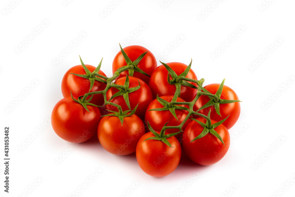 Fresh cherry tomatoes with a sprig isolated on a white background. Tomato branch. Fresh tomatoes with green leaves. Fresh cherry tomatoes with a sprig isolated on a white background. Tomato branch. Fresh tomatoes with green leaves.