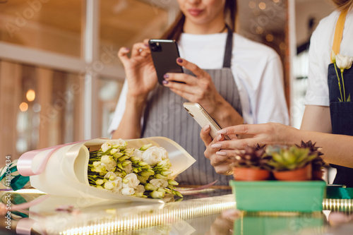 Flower shop workers take a photo of the finished bouquet.