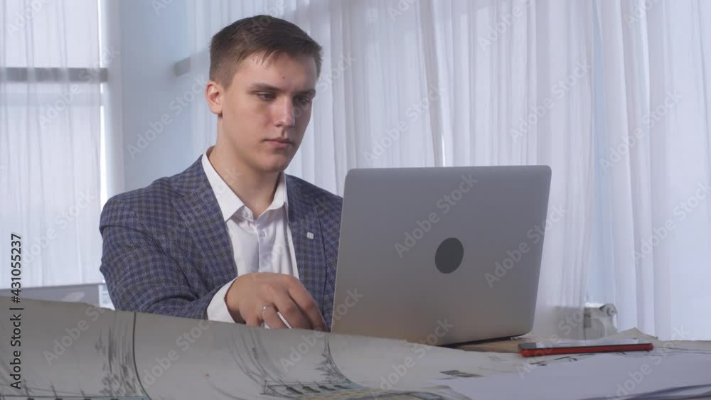 Architect Working on Laptop Create Architectural Design Building Real Estate. Man Designer Freelancer Looking At Screen Notebook Computer. Young Engineer Creator Architecture Working Office Workplace. Architect Working on Laptop Create Architectural Design Building Real Estate. Man Designer Freelancer Looking At Screen Notebook Computer. Young Engineer Creator Architecture Working Office Workplace.