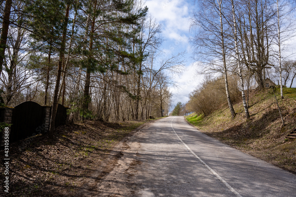 Fototapeta premium asphalt road on a sunny day leading up the hill