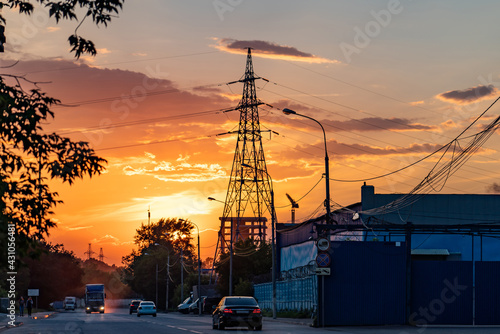 High-voltage power lines over sunset background
