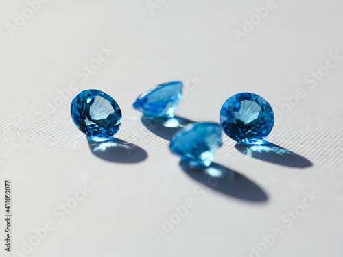 Four topaz gemstones on flat surface, round cut