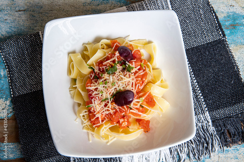 Fettuccine pasta with fresh homemade tomato sauce and parsley photo