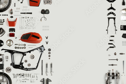 Top view of disassembled motorcycle on a light background with copy space