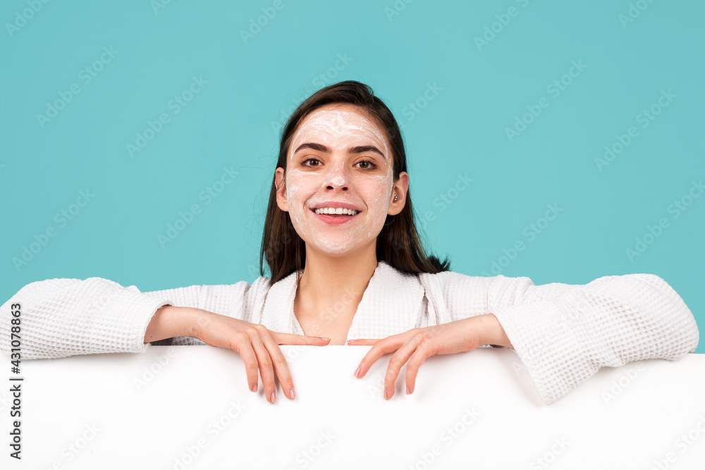 Woman apply facial cream. Beauty portrait of beautiful female model with facial mask cream, isolated. Banner with copy space, empty space. Woman apply facial cream. Beauty portrait of beautiful female model with facial mask cream, isolated. Banner with copy space, empty space.