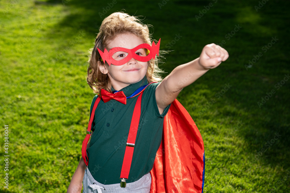Superhero child against spring green field outdoor. Freedom and imagination kids concept. Superhero child against spring green field outdoor. Freedom and imagination kids concept.