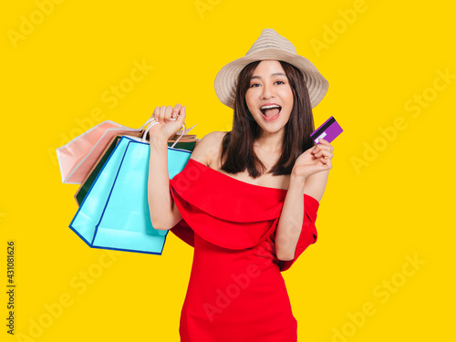  young women dressed in summer clothes holding shopping bags and credit card