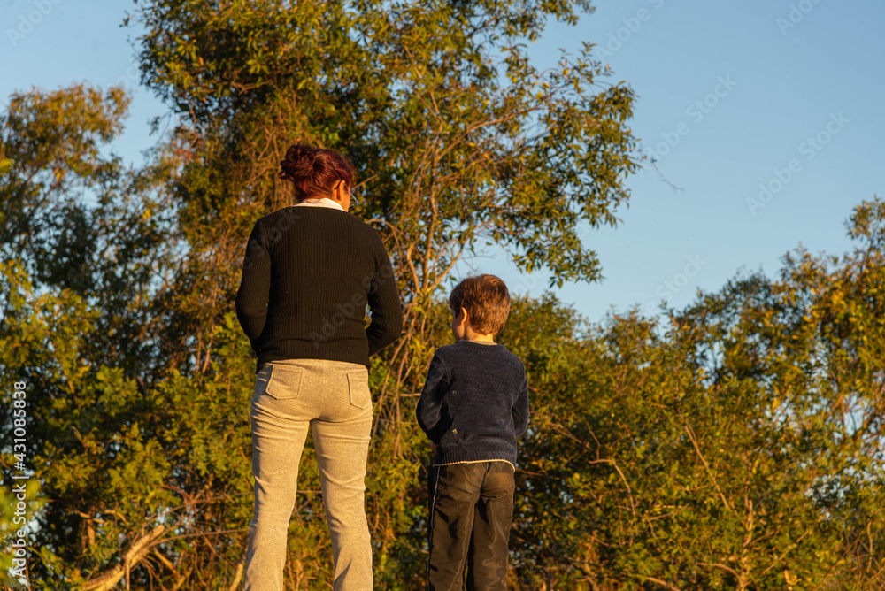 Brazilian woman and boy contemplating nature