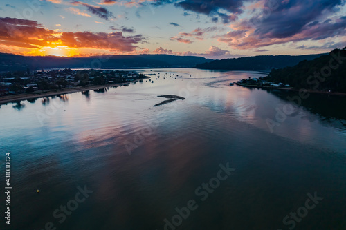 Fototapeta Naklejka Na Ścianę i Meble -  Aerial sunrise waterscape with boats and cloud cover