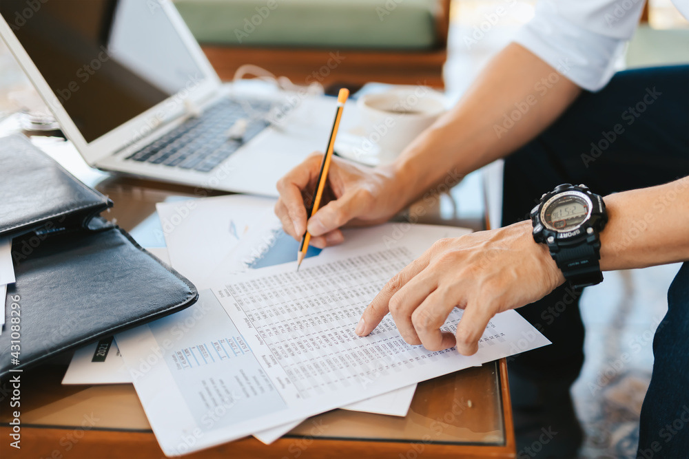 Administrator businessman making report, calculating balance. Business analyzing income charts, graphs and data on the table. Administrator businessman making report, calculating balance. Business analyzing income charts, graphs and data on the table.