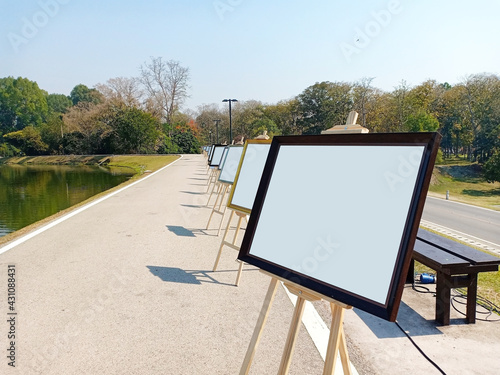 Blank white background of Art exhibition, Art gallery, collection of artwork on the street near the pond in the public park.