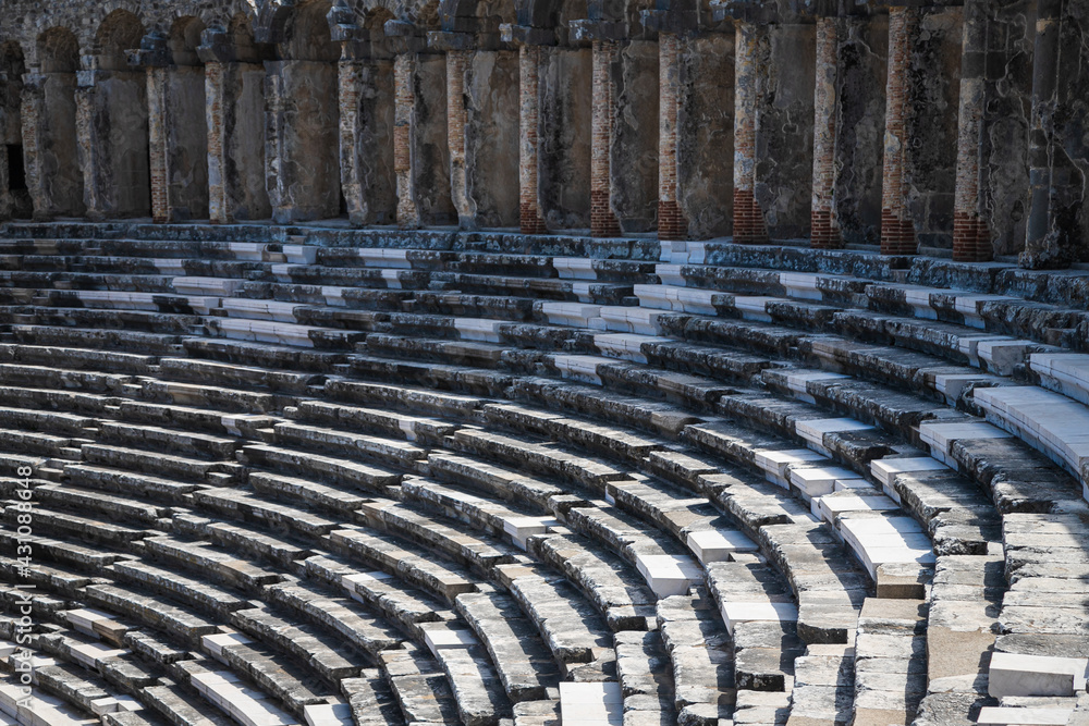Aspendos Amphitheater close-up inside in the summertime with sunshine, Turkey, Serik. Aspendos Amphitheater close-up inside in the summertime with sunshine, Turkey, Serik.