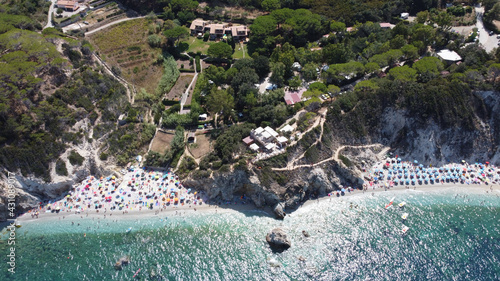 Aerial view of the coastline washed by blue ocean waves at the Tuscan Archipelago National Park