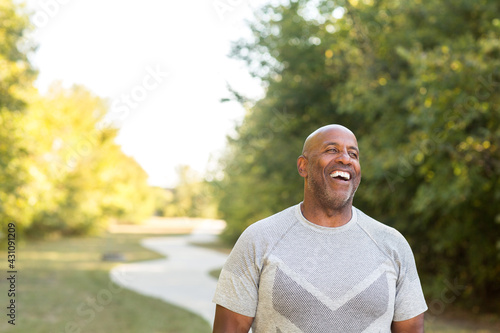 Mature African American man taking a walk outside.