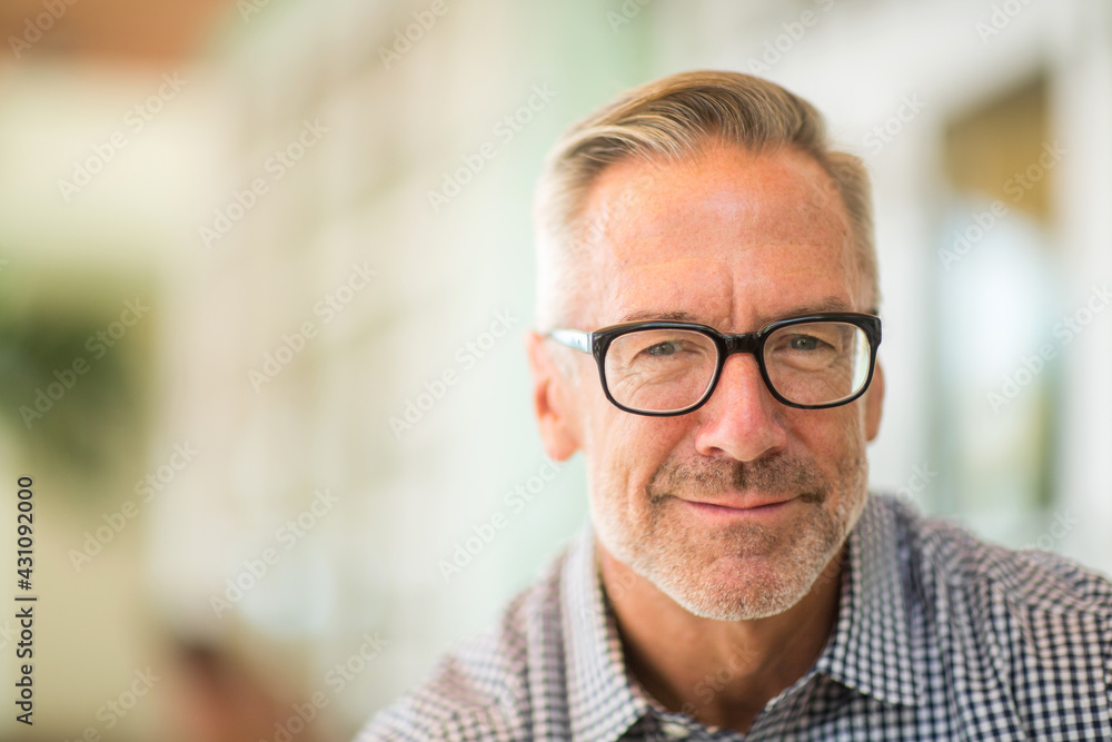 Fototapeta premium Mature handome fit man sitting outside stock photo