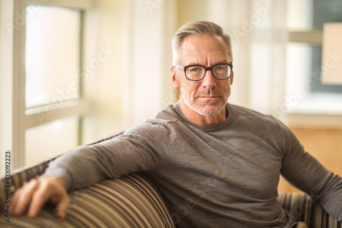 фотографія Mature man sitting on a sofa sock photo