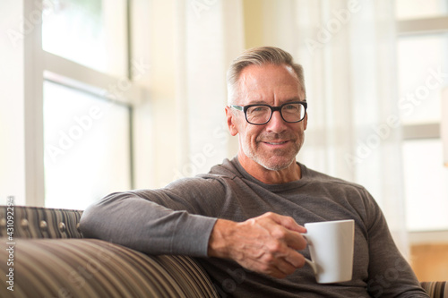Mature man sitting on a sofa sock photo photo