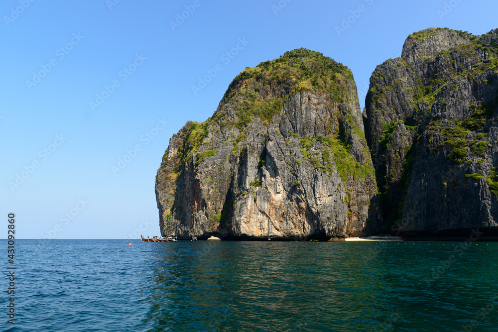 Thai traditional long-tailed boats moored in front of the western part of Ao Maya, Koh Phi Phi Le, Krabi, Thailand.