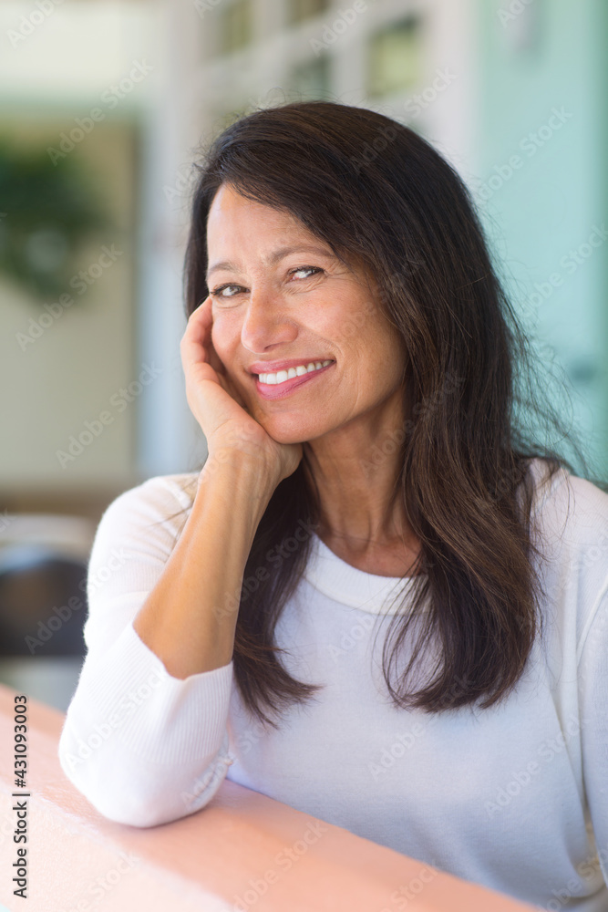 Portrait of a beautiful mature woman sitting on the sofa