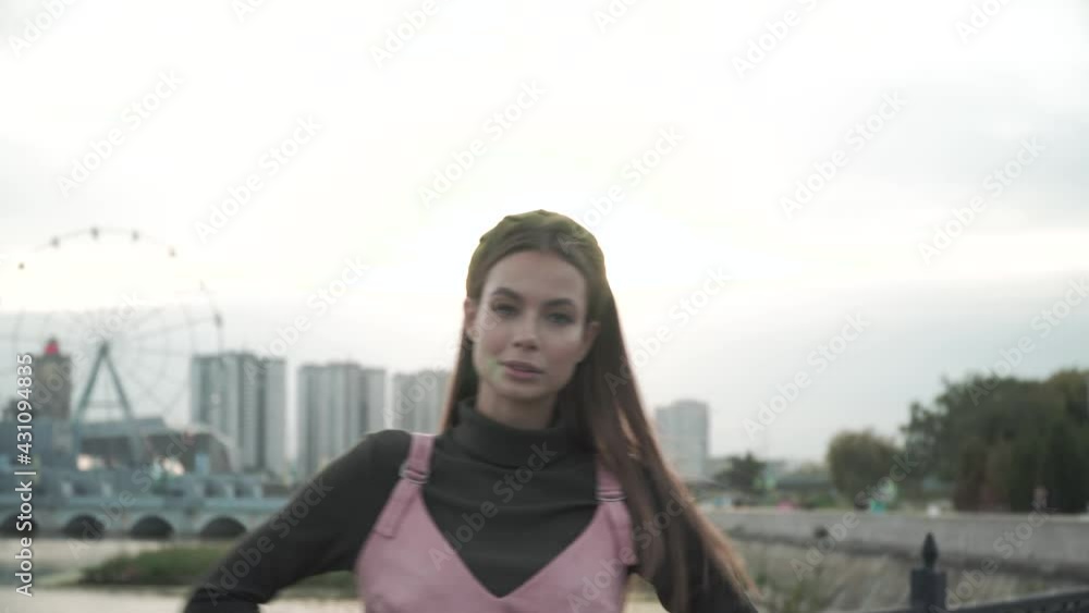 A girl goes and walks on a bridge in the city. 4k A girl goes and walks on a bridge in the city. 4k