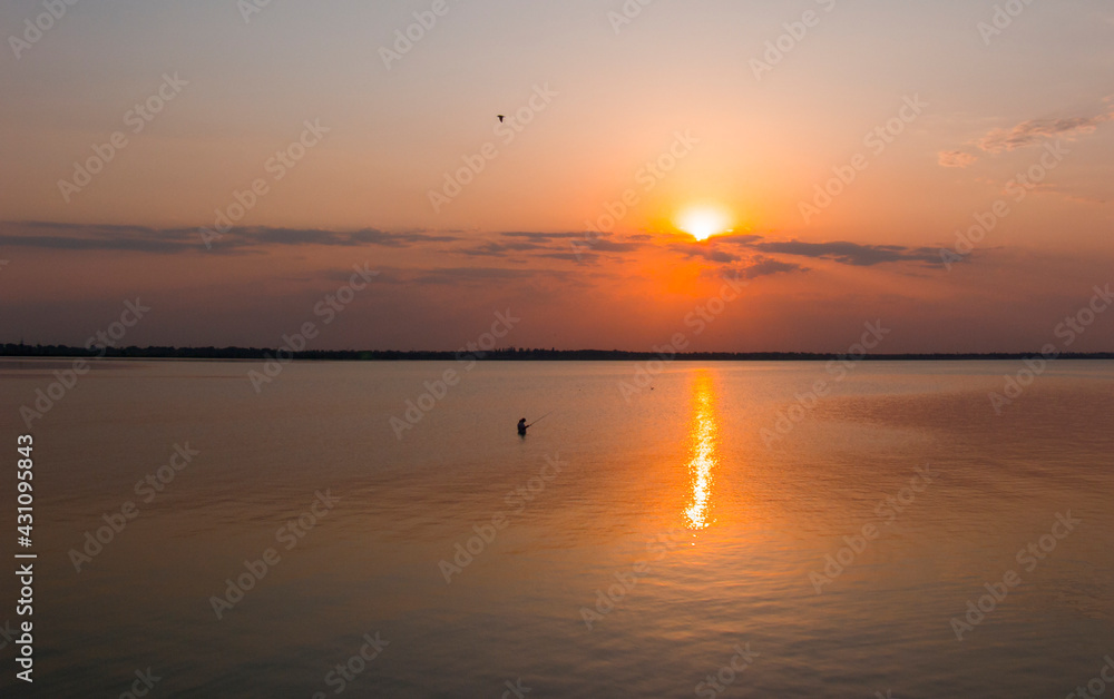 Fishing at sunset time at a Dniester Liman near Zatoka town in Ukraine Fishing at sunset time at a Dniester Liman near Zatoka town in Ukraine