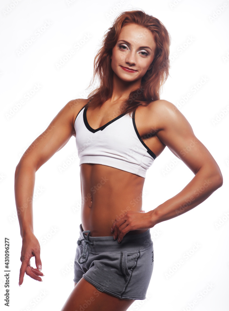Photo of cheerful young woman dressed sportwear over white background. Photo of cheerful young woman dressed sportwear over white background.