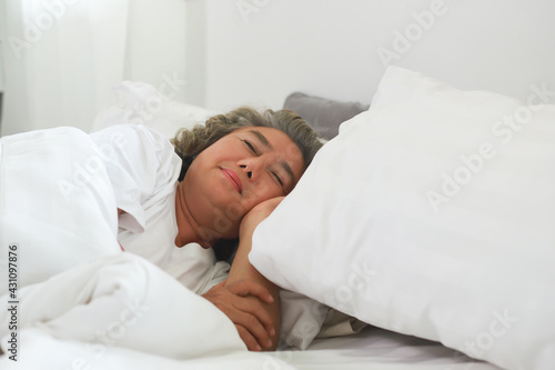 Asian Elderly woman sleep and sweet dream on bed in morning.